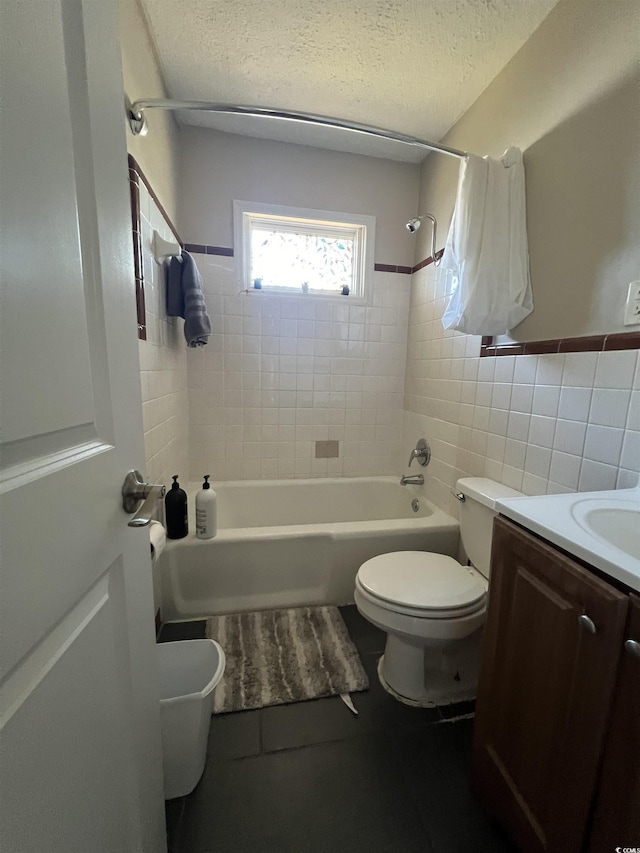 706 Mitchell Dr, Myrtle Beach, SC 29577 - bathroom featuring tile walls, toilet, bathtub / shower combination, vanity, and a textured ceiling