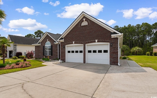 ranch-style house featuring brick siding, a front lawn, a garage, and concrete driveway