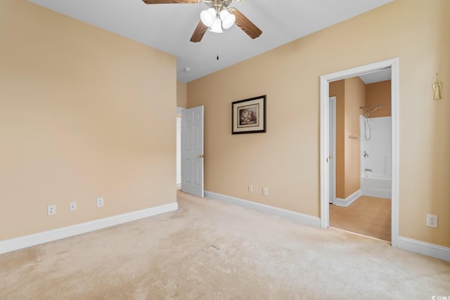 unfurnished bedroom with ceiling fan, ensuite bathroom, baseboards, and carpet floors