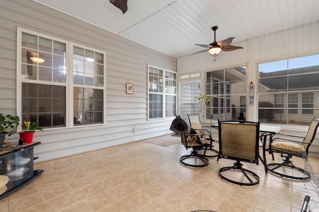 sunroom with ceiling fan and outdoor dining space