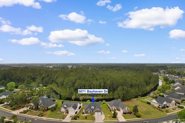 birds eye view of property with a forest view and a residential view