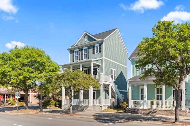 view of front of property featuring covered porch and stairs