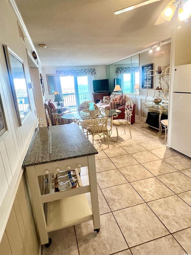 6000 Ocean Blvd N Unit 108, North Myrtle Beach, SC 29582 - kitchen with freestanding refrigerator, light tile patterned floors, healthy amount of natural light, crown molding, and a textured ceiling