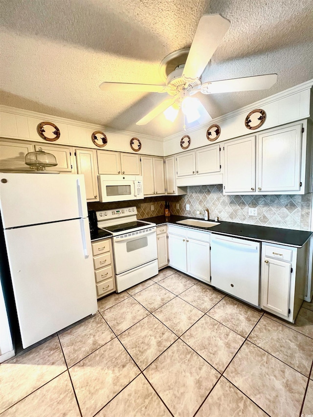 6000 Ocean Blvd N Unit 108, North Myrtle Beach, SC 29582 - kitchen featuring white appliances, dark countertops, a textured ceiling, crown molding, and decorative backsplash