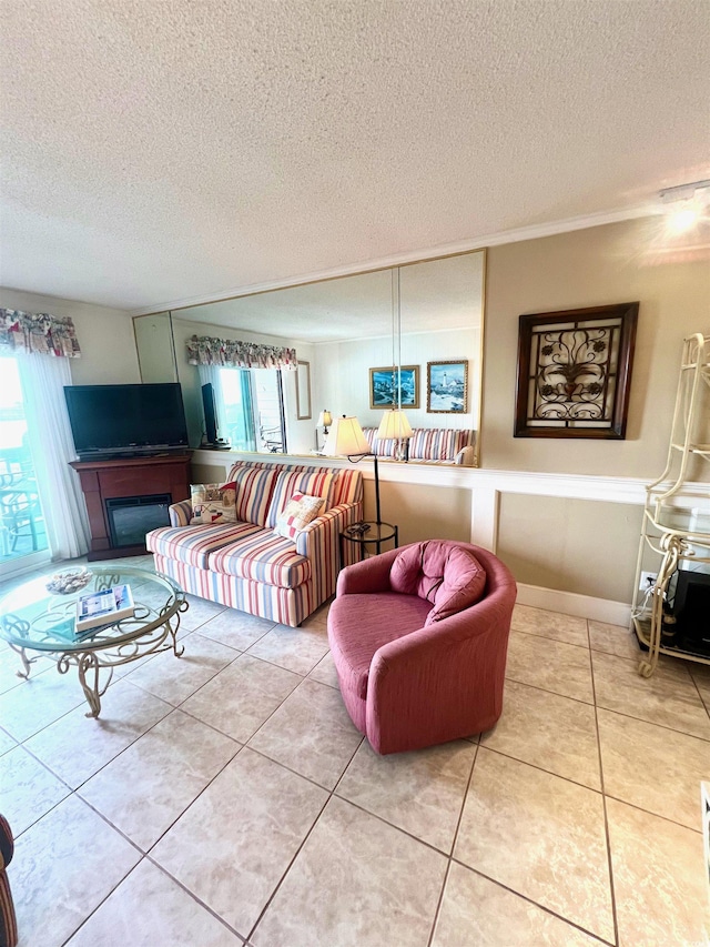 6000 Ocean Blvd N Unit 108, North Myrtle Beach, SC 29582 - tiled living room with healthy amount of natural light, a textured ceiling, and a glass covered fireplace