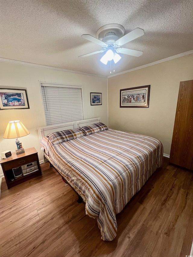 6000 Ocean Blvd N Unit 108, North Myrtle Beach, SC 29582 - bedroom with wood finished floors, ornamental molding, a textured ceiling, and a ceiling fan