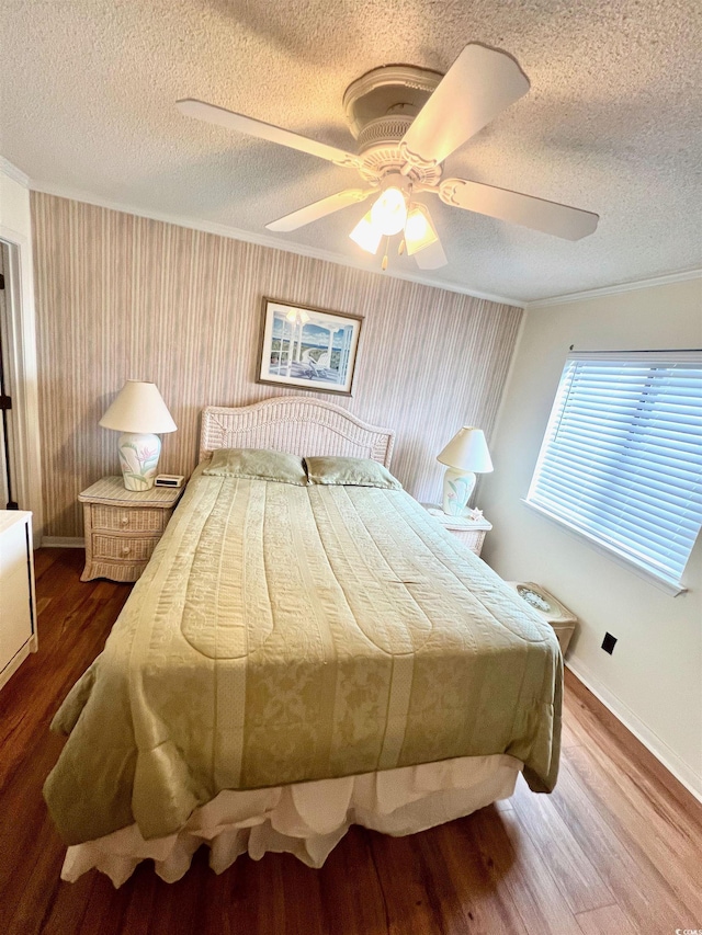 6000 Ocean Blvd N Unit 108, North Myrtle Beach, SC 29582 - bedroom with a textured ceiling, ornamental molding, wood finished floors, baseboards, and ceiling fan