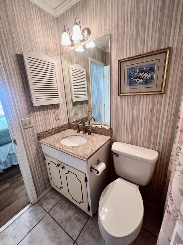 6000 Ocean Blvd N Unit 108, North Myrtle Beach, SC 29582 - bathroom featuring wallpapered walls, vanity, toilet, tile patterned floors, and baseboards