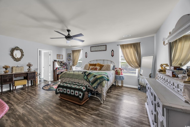 bedroom featuring baseboards, visible vents, dark wood-type flooring, and ceiling fan