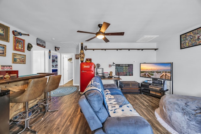 living room with wood finished floors and ceiling fan