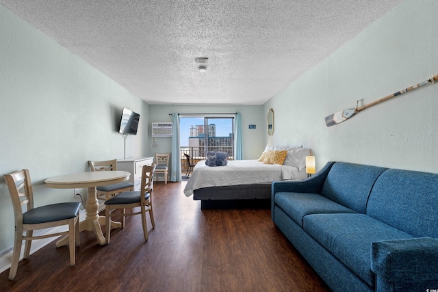 1207 S Ocean Blvd S Unit 51107, Myrtle Beach, SC 29577 - bedroom featuring dark wood finished floors, a textured ceiling, a textured wall, and a wall mounted air conditioner