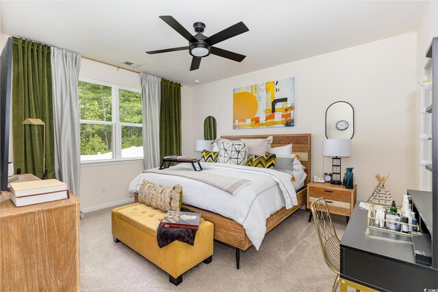 bedroom featuring light colored carpet, visible vents, ceiling fan, and baseboards