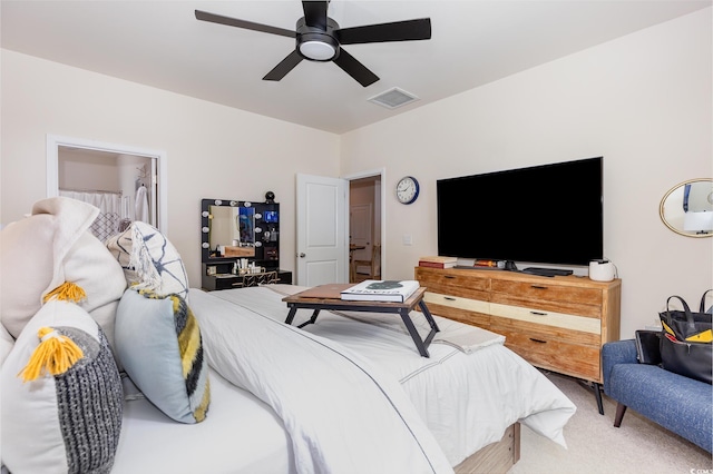 carpeted bedroom featuring visible vents and a ceiling fan