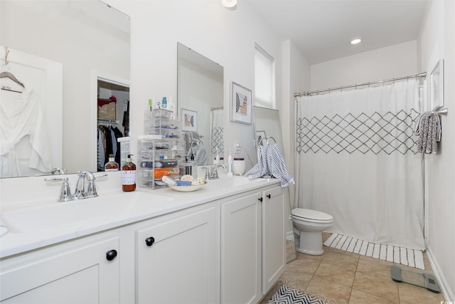full bath with double vanity, toilet, tile patterned flooring, and a sink