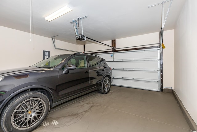 garage with baseboards and a garage door opener