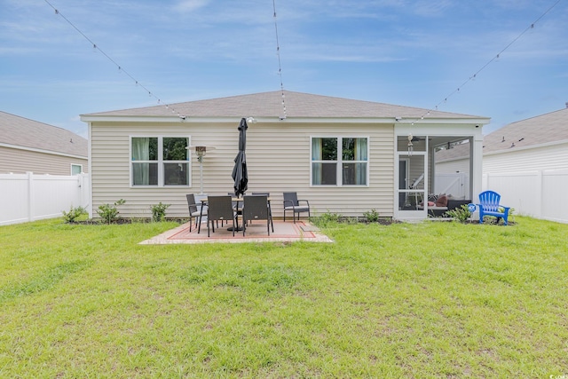 rear view of property with a patio, a fenced backyard, and a lawn