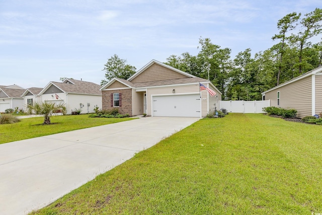 view of front of property featuring a front lawn, driveway, an attached garage, and fence
