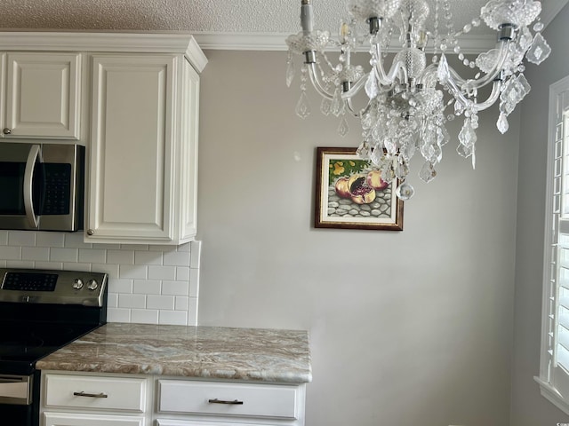 1516 Saint George Ln, Myrtle Beach, SC 29588 - room details with an inviting chandelier, ornamental molding, tasteful backsplash, light stone counters, and appliances with stainless steel finishes