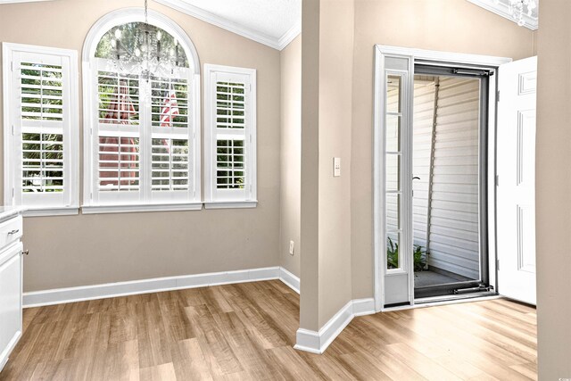 1516 Saint George Ln, Myrtle Beach, SC 29588 - entryway featuring crown molding, vaulted ceiling, baseboards, a chandelier, and light wood-style floors