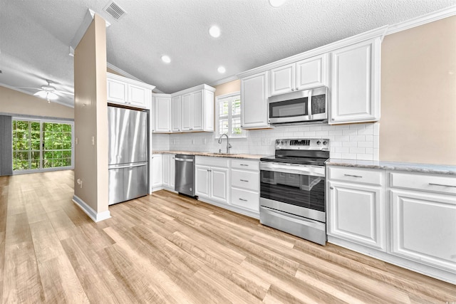 1516 Saint George Ln, Myrtle Beach, SC 29588 - kitchen featuring visible vents, lofted ceiling, plenty of natural light, a textured ceiling, and stainless steel appliances