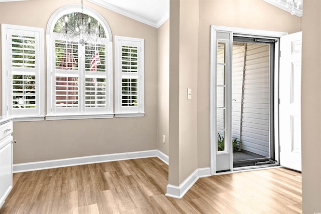 1516 Saint George Ln, Myrtle Beach, SC 29588 - entryway featuring crown molding, vaulted ceiling, baseboards, a chandelier, and light wood-style floors