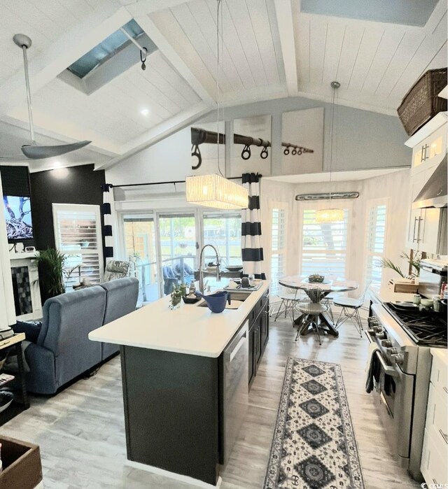 6001-Z55 S Kings Hwy, Myrtle Beach, SC 29575 - kitchen with an island with sink, stainless steel appliances, light countertops, vaulted ceiling with beams, and a sink