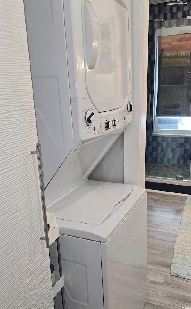6001-Z55 S Kings Hwy, Myrtle Beach, SC 29575 - clothes washing area featuring stacked washer and dryer, laundry area, and wood finished floors