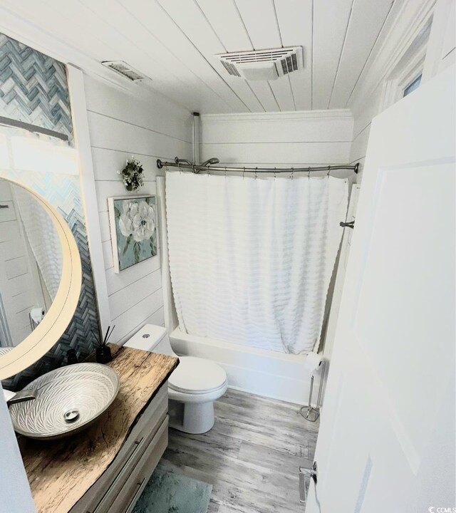 6001-Z55 S Kings Hwy, Myrtle Beach, SC 29575 - bathroom featuring visible vents, shower / bathtub combination with curtain, ornamental molding, and toilet