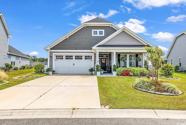 craftsman inspired home with an attached garage, driveway, and a front yard