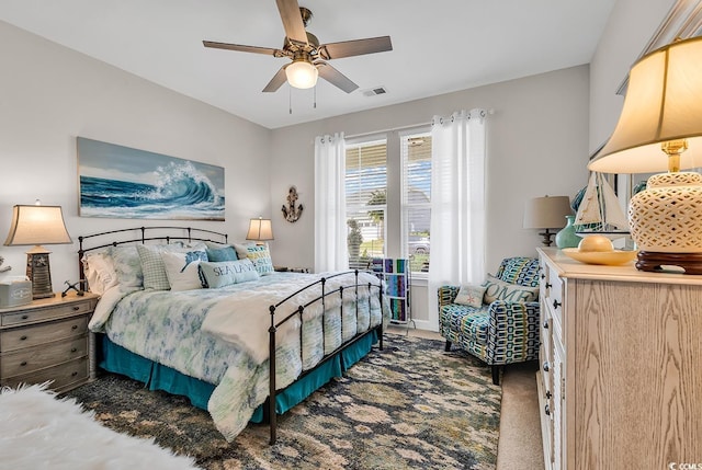 carpeted bedroom with visible vents and a ceiling fan