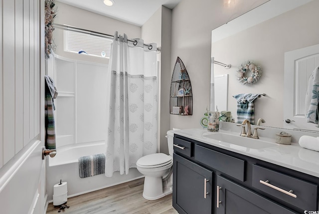 full bathroom with shower / tub combo with curtain, toilet, vanity, and wood finished floors