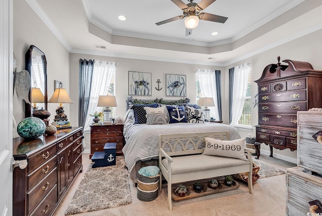 bedroom with visible vents, a raised ceiling, and multiple windows
