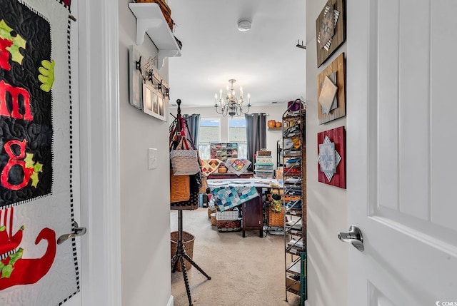 hallway featuring carpet flooring and a notable chandelier