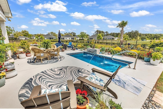 view of swimming pool featuring a fenced backyard, a residential view, a patio, and a fenced in pool