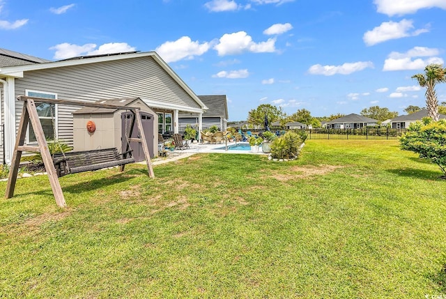 view of yard with fence, a patio area, and a fenced in pool