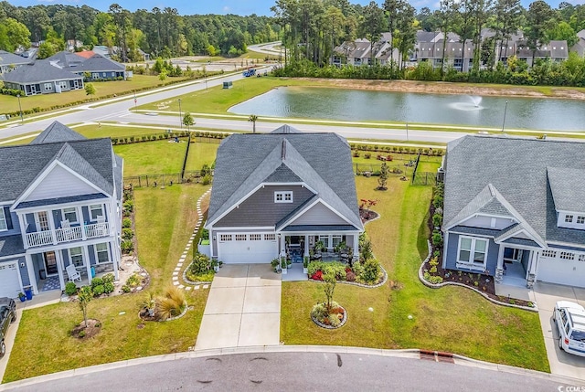birds eye view of property with a water view and a residential view
