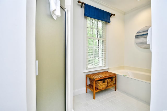 full bath with crown molding, a bath, tile patterned floors, a shower stall, and baseboards