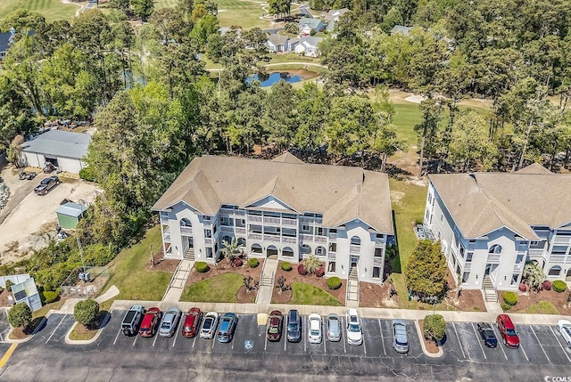 aerial view with a water view and golf course view