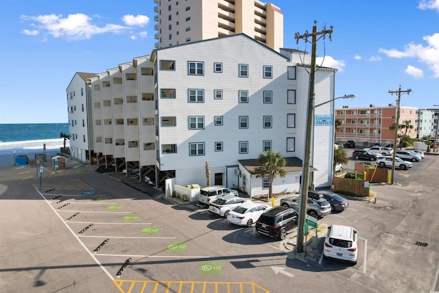 view of building exterior featuring uncovered parking
