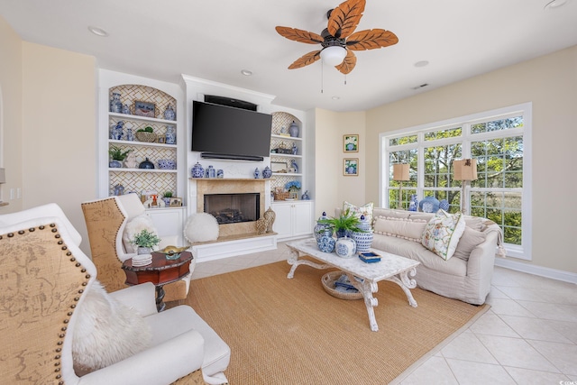 2278 Big Landing Dr, Little River, SC 29566 - living area with ceiling fan, a high end fireplace, built in features, and light tile patterned floors