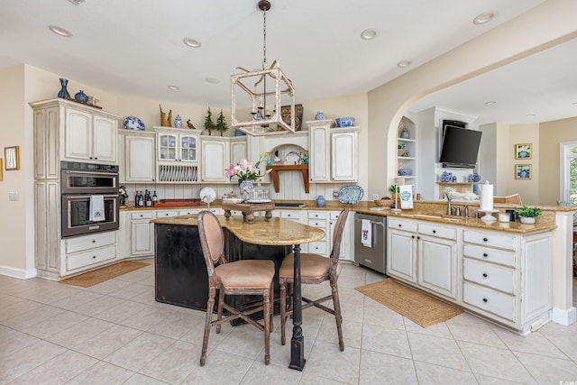 2278 Big Landing Dr, Little River, SC 29566 - kitchen with dishwasher, light tile patterned floors, a sink, a peninsula, and multiple ovens
