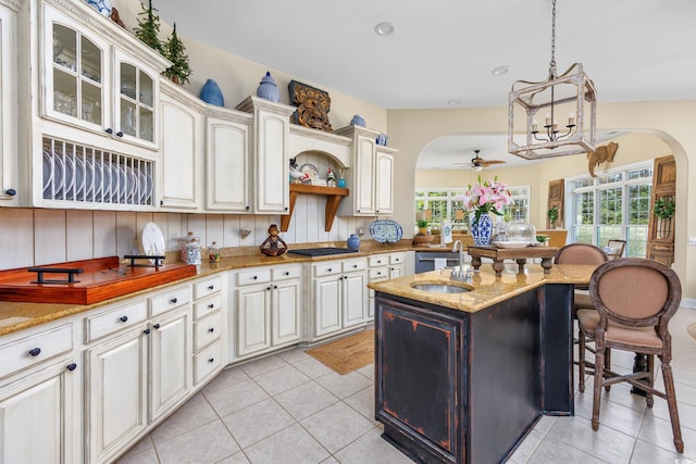 2278 Big Landing Dr, Little River, SC 29566 - kitchen featuring a ceiling fan, gas cooktop, arched walkways, light tile patterned floors, and a sink