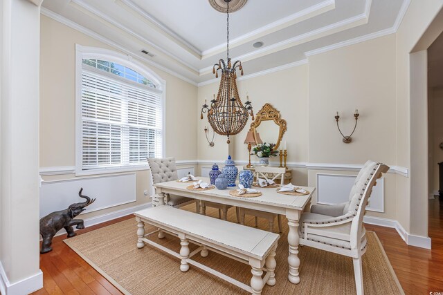 2278 Big Landing Dr, Little River, SC 29566 - dining room with wood finished floors, an inviting chandelier, ornamental molding, and a tray ceiling