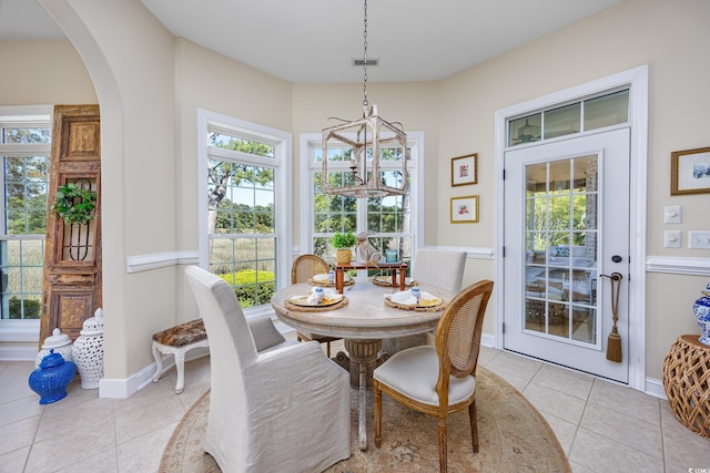 2278 Big Landing Dr, Little River, SC 29566 - dining area with arched walkways, visible vents, baseboards, and light tile patterned floors