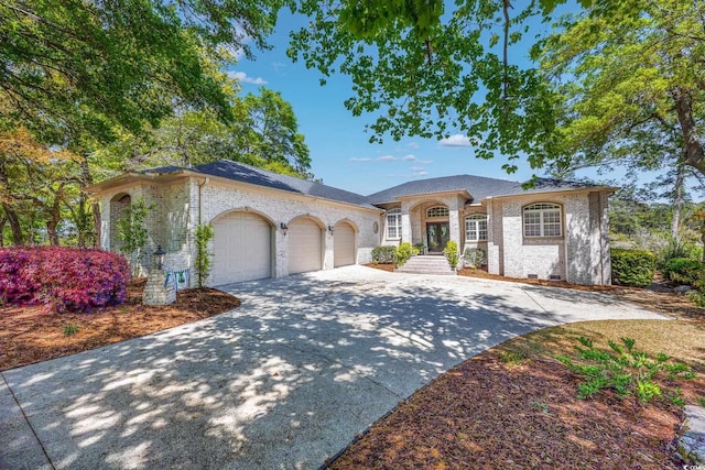 2278 Big Landing Dr, Little River, SC 29566 - mediterranean / spanish house featuring brick siding, an attached garage, and driveway