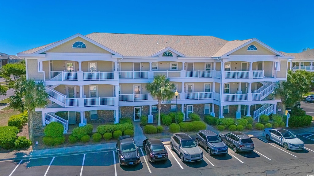6203 Catalina Dr Unit 633, North Myrtle Beach, SC 29582 - view of property with uncovered parking and stairway