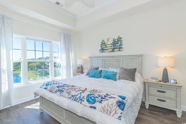 bedroom with a ceiling fan, wood finished floors, baseboards, ornamental molding, and visible vents