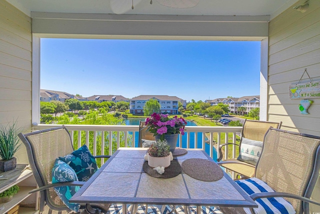 balcony with outdoor dining space and a residential view