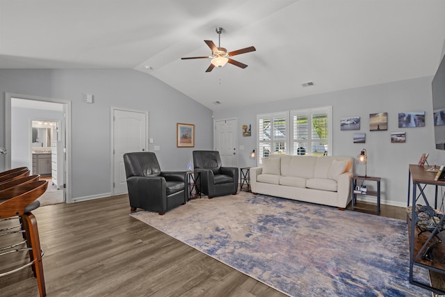 living area with wood finished floors, visible vents, baseboards, ceiling fan, and vaulted ceiling