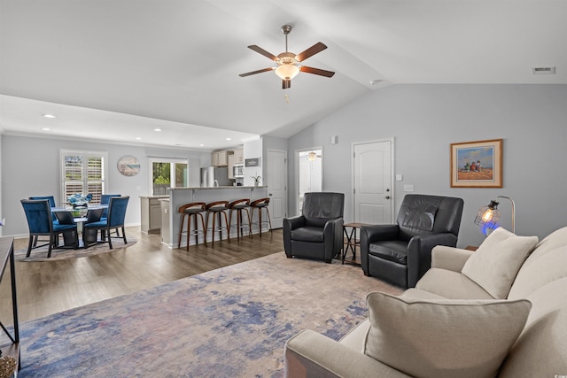 living room featuring wood finished floors, visible vents, recessed lighting, vaulted ceiling, and ceiling fan